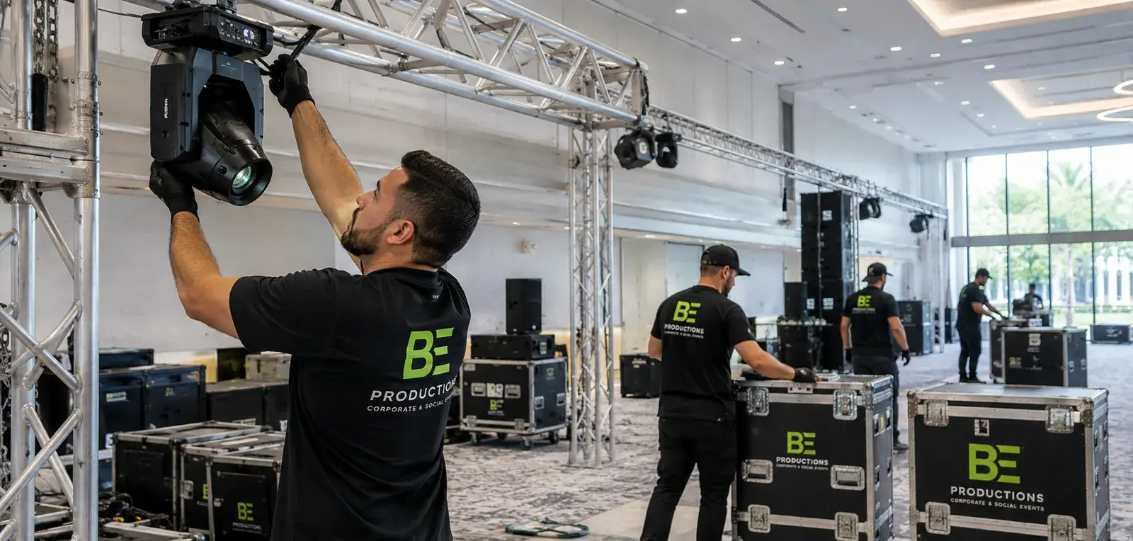 BE Productions crew member setting up event rigging and lighting equipment