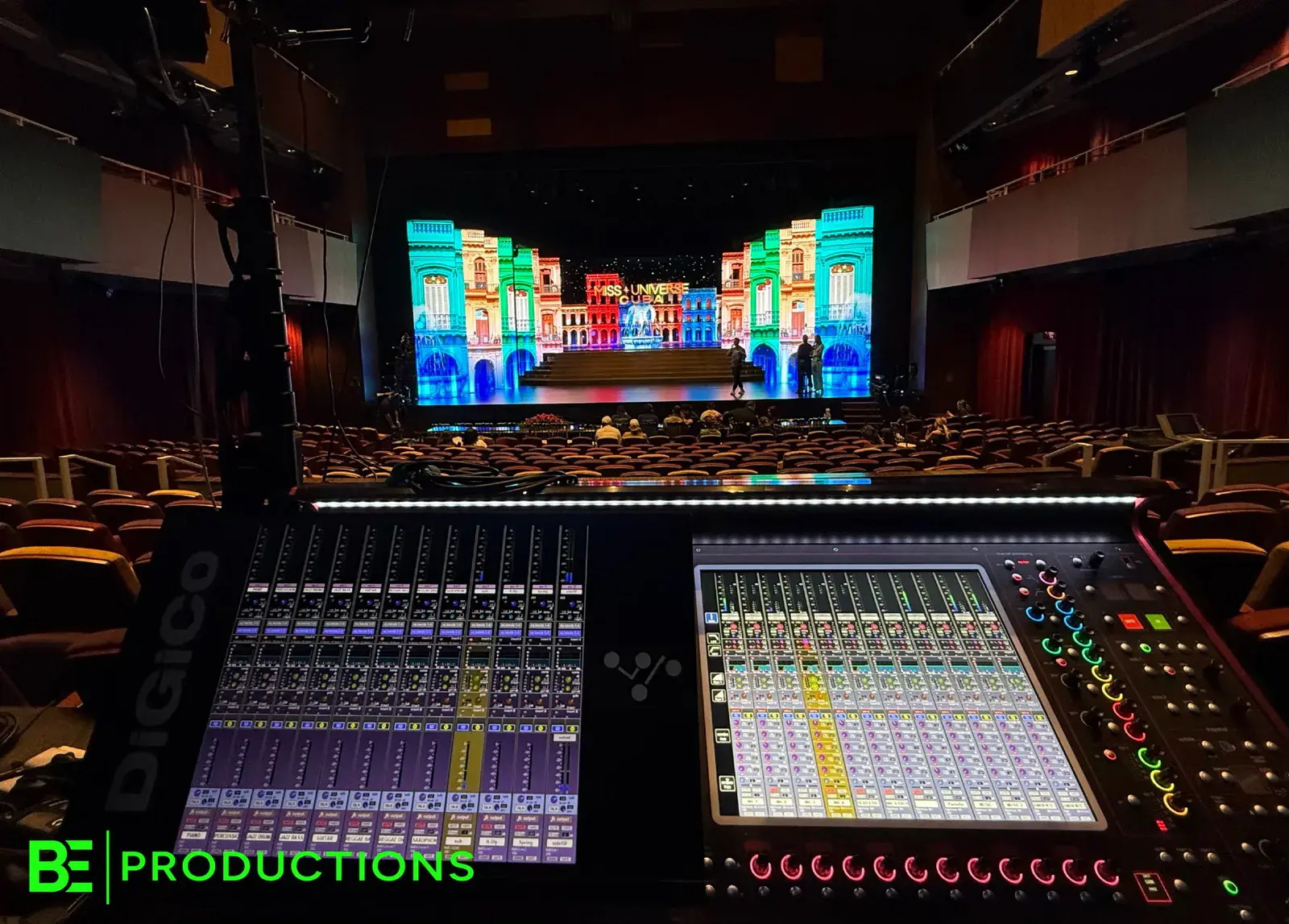 Digital audio mixing desks facing the stage during a BE sound check