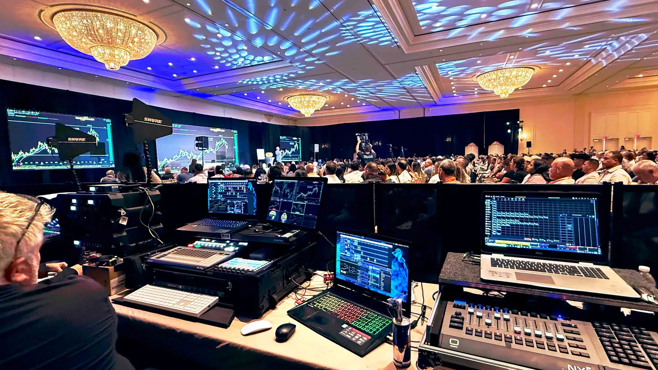 Corporate leadership summit with audience, stage, LED visuals, and professional lighting